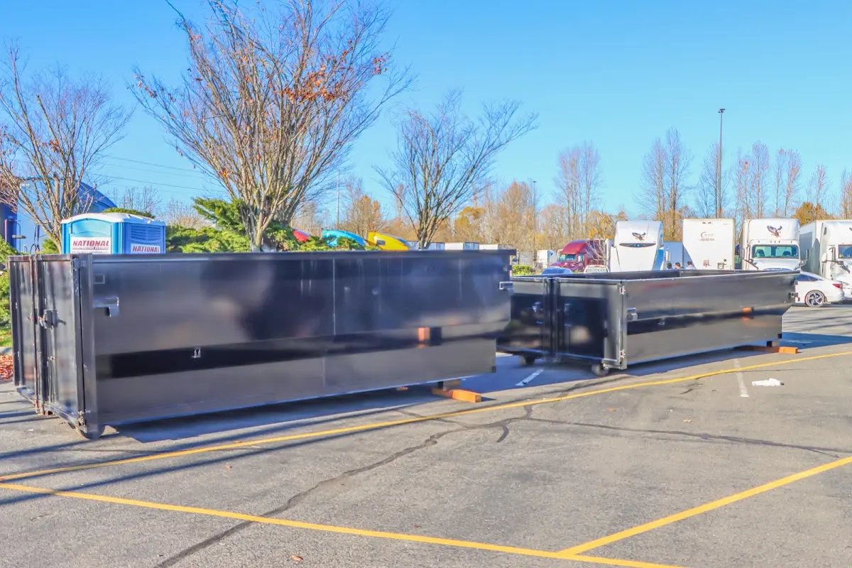 Professional dumpster rental service with roll-off container on residential driveway in Flatwoods